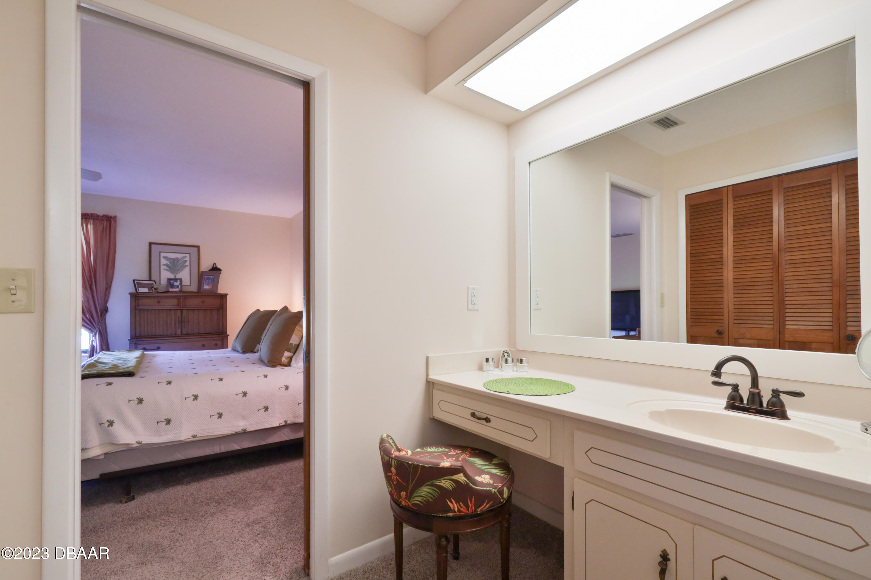 118 Sand Dunes Drive Ormond Beach, FL 32176 - Photo 32 of 46 a bedroom with a bed and a chair