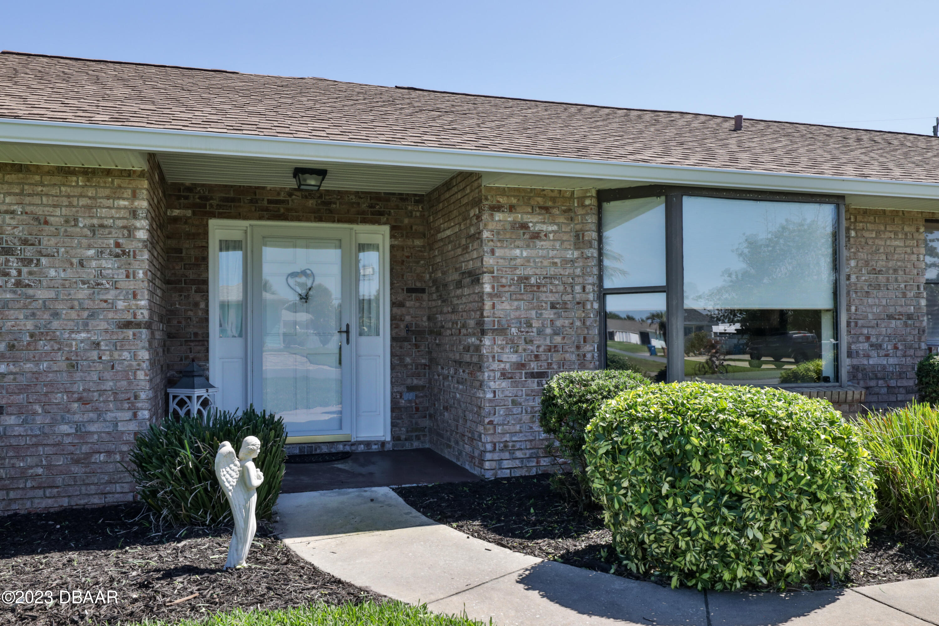 118 Sand Dunes Drive Ormond Beach, FL 32176 - Photo 7 of 46 a front view of a house with garden