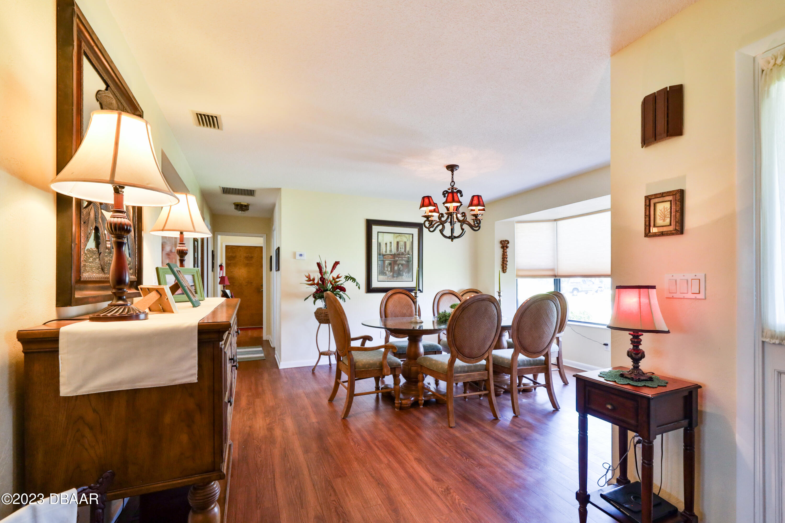 118 Sand Dunes Drive Ormond Beach, FL 32176 - Photo 10 of 46 a view of a dining room with furniture window and wooden floor