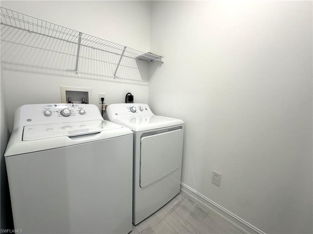 7509 Carnegie Way Naples, FL 34119 - Photo 11 of 33 a utility room with dryer and washer