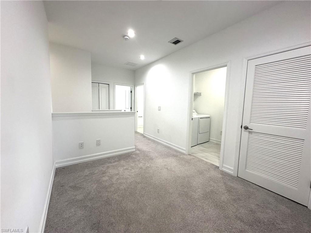 7509 Carnegie Way Naples, FL 34119 - Photo 13 of 33 an empty room with a empty space and windows