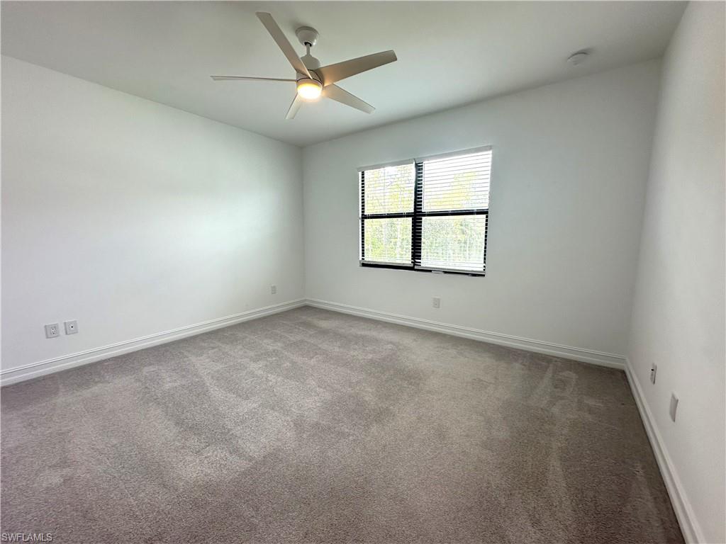 7509 Carnegie Way Naples, FL 34119 - Photo 14 of 33 an empty room with a window