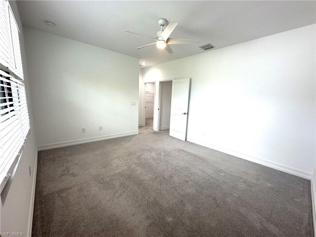 7509 Carnegie Way Naples, FL 34119 - Photo 15 of 33 an empty room with a ceiling fan and window