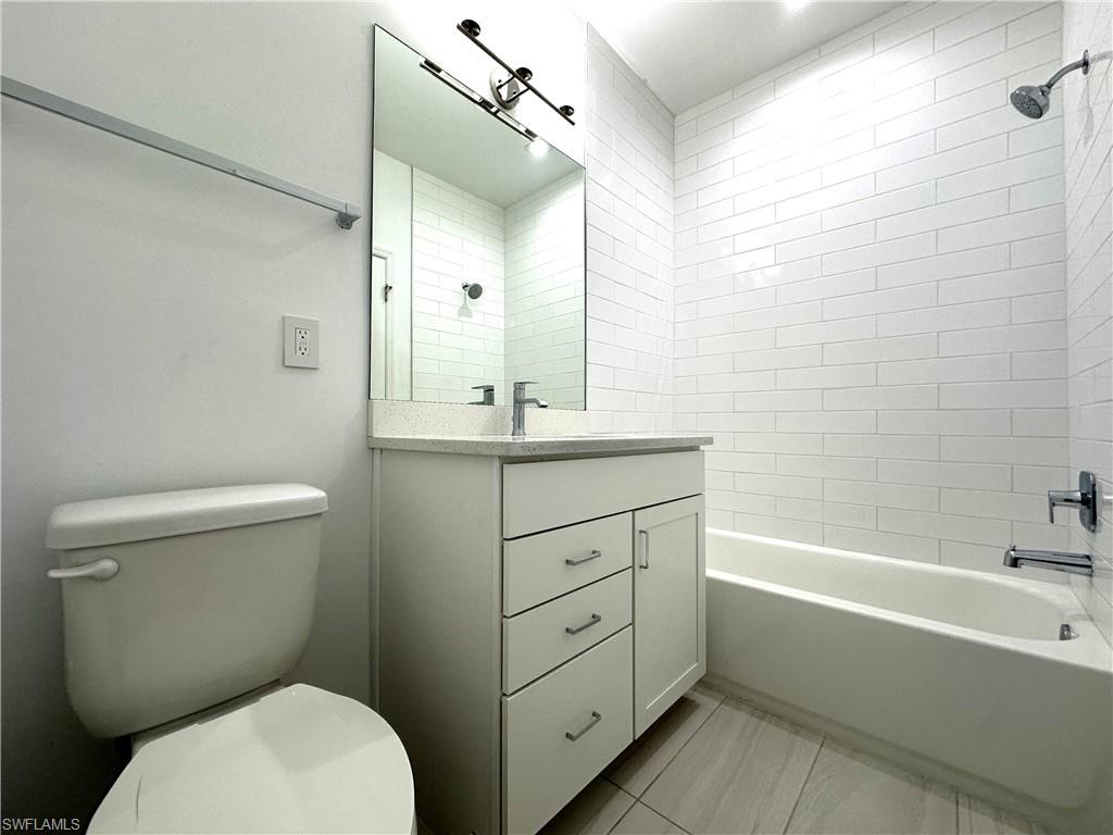 7509 Carnegie Way Naples, FL 34119 - Photo 22 of 33 a bathroom with a sink a toilet and shower