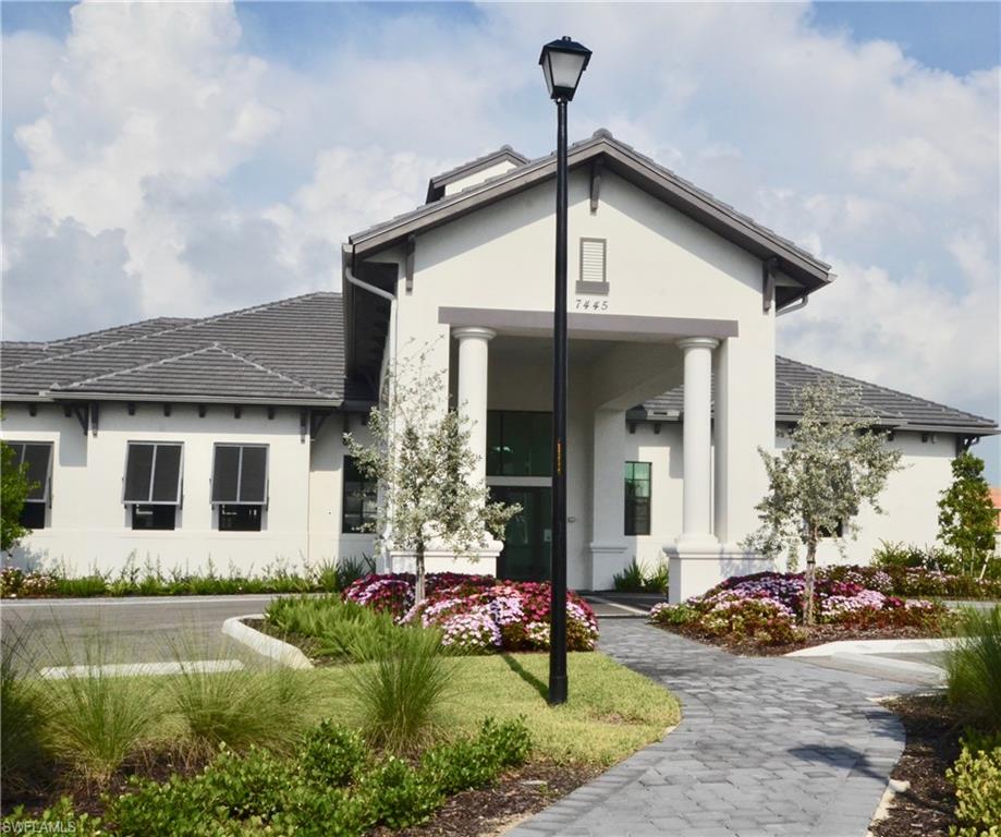 7509 Carnegie Way Naples, FL 34119 - Photo 29 of 33 a front view of a house with garden