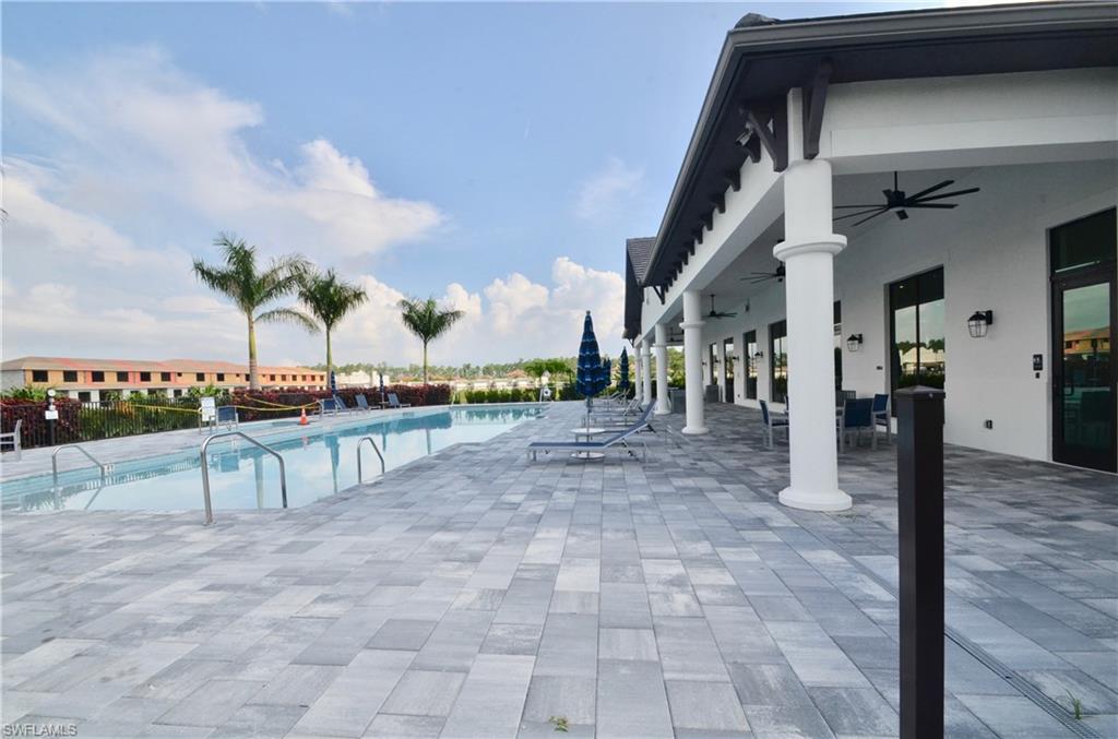 7509 Carnegie Way Naples, FL 34119 - Photo 32 of 33 a view of a patio with a table and chairs