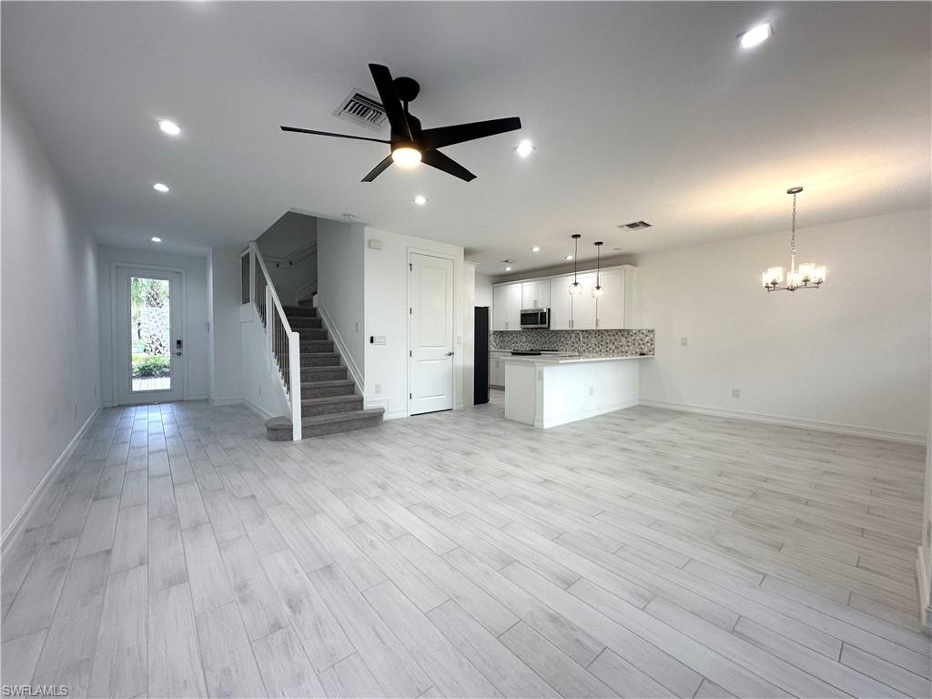 7509 Carnegie Way Naples, FL 34119 - Photo 7 of 33 a view of a kitchen with a sink and a refrigerator