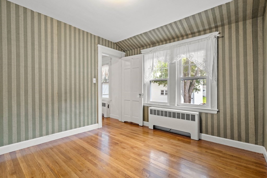6 Palmer Road Marblehead, MA 01945 - Photo 13 of 23 a view of an empty room with wooden floor and a window