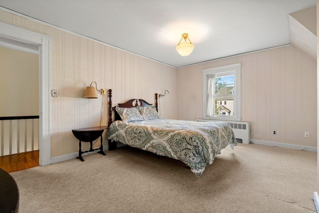 6 Palmer Road Marblehead, MA 01945 - Photo 15 of 23 a bedroom with a bed and a chandelier