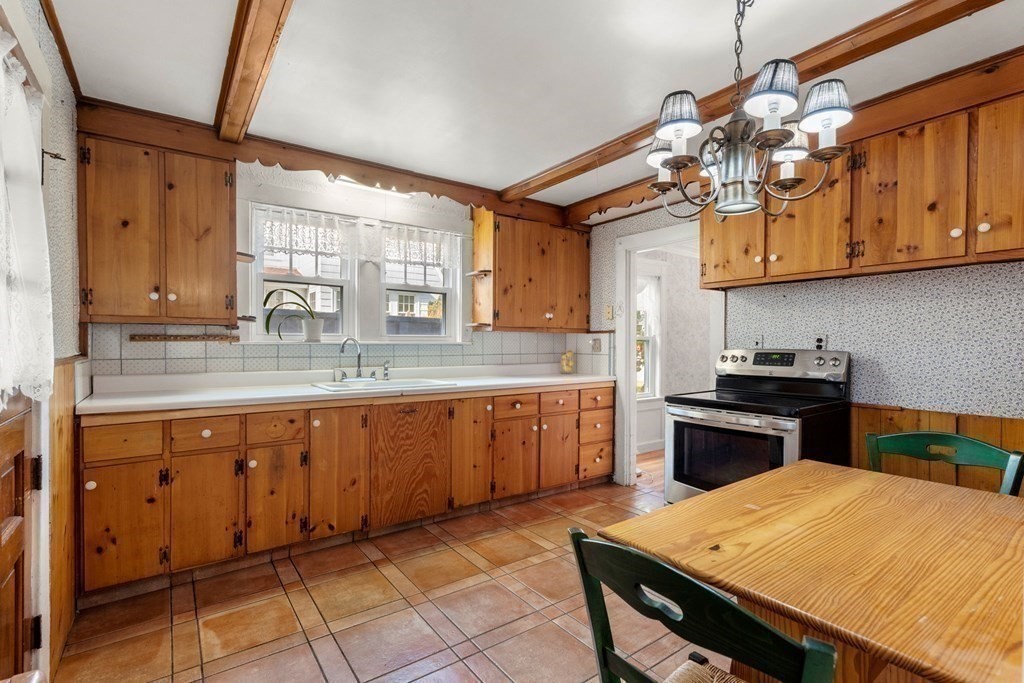 6 Palmer Road Marblehead, MA 01945 - Photo 9 of 23 a kitchen with stainless steel appliances granite countertop a sink dishwasher a stove a refrigerator cabinets and dining table