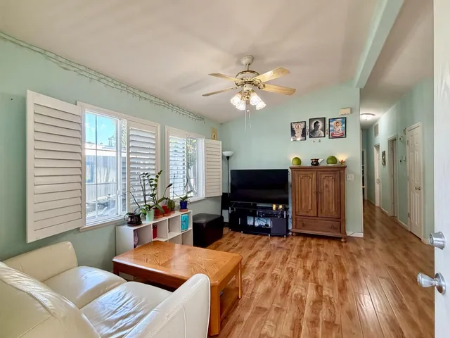 a living room with furniture flat screen tv and window