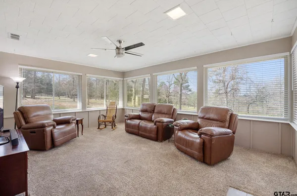 a table and chairs in a room next to a window