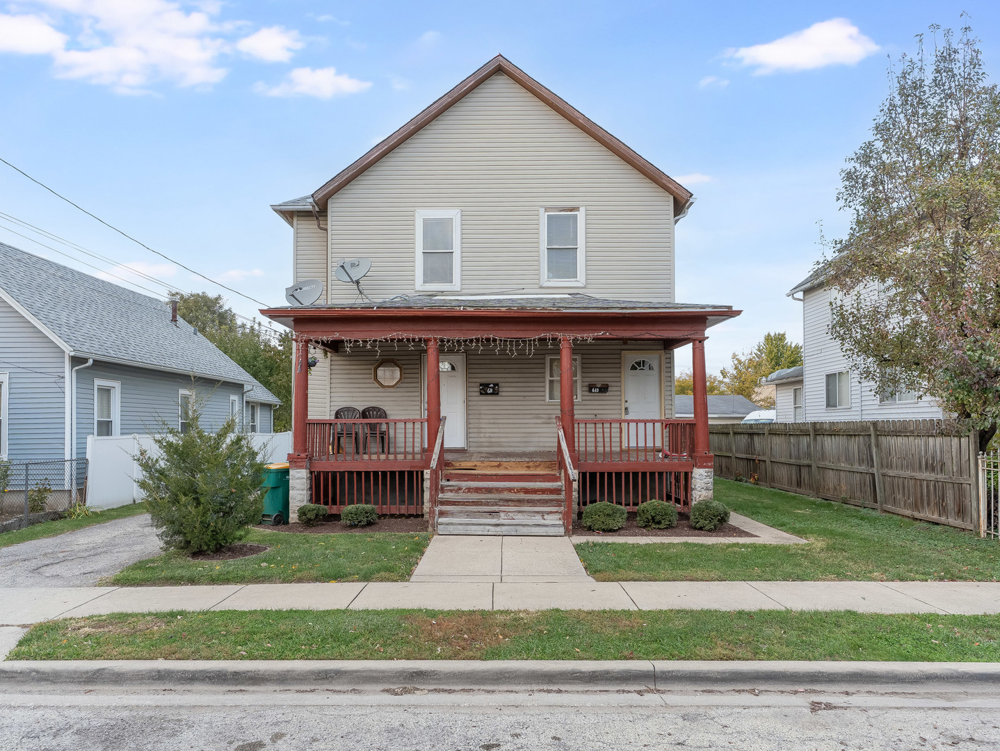a front view of a house with a garden