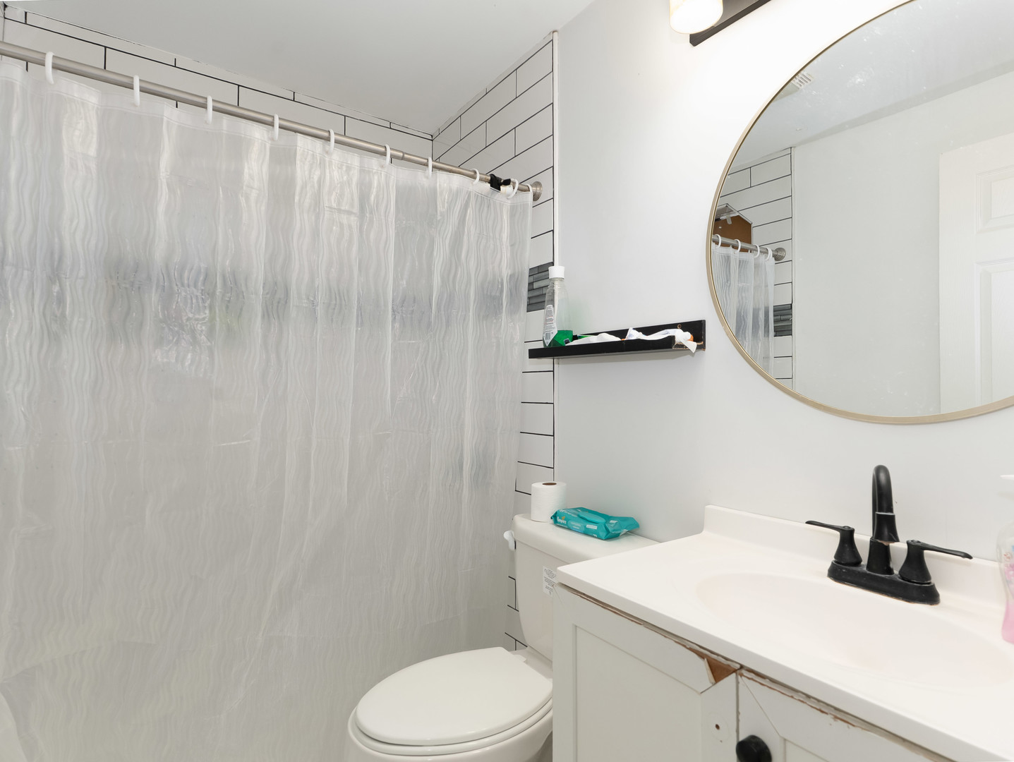 611 Jerome Avenue Joliet, IL 60432 - Photo 14 of 17 a bathroom with a sink a toilet and a mirror