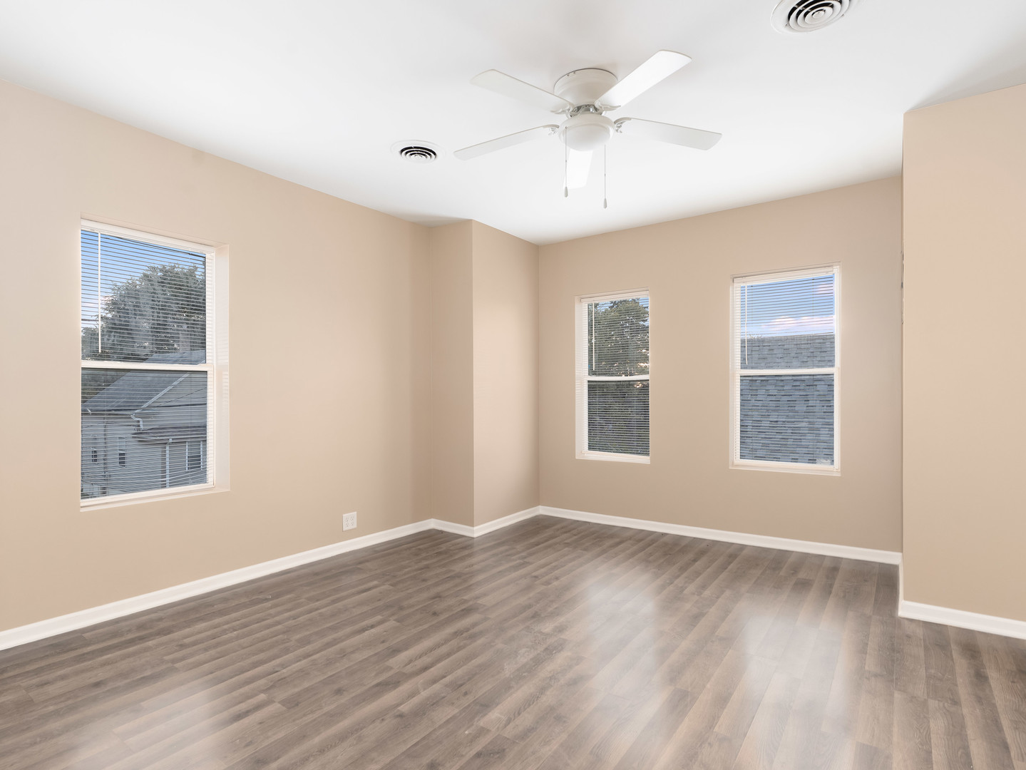 611 Jerome Avenue Joliet, IL 60432 - Photo 2 of 17 a view of an empty room with a window and wooden floor