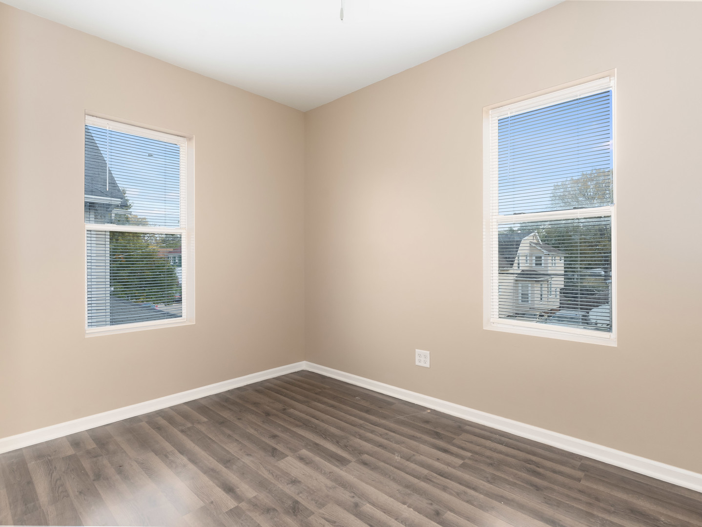 611 Jerome Avenue Joliet, IL 60432 - Photo 6 of 17 a view of an empty room with wooden floor and a window