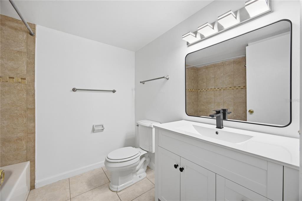 925 West Oak Ridge Road, Unit 925C Orlando, FL 32809 - Photo 9 of 15 a bathroom with a sink a toilet and shower