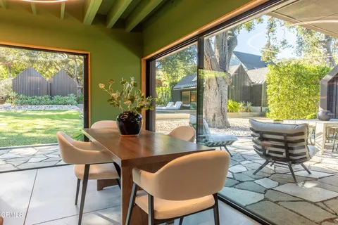 a bedroom with a bed and painting on the wall