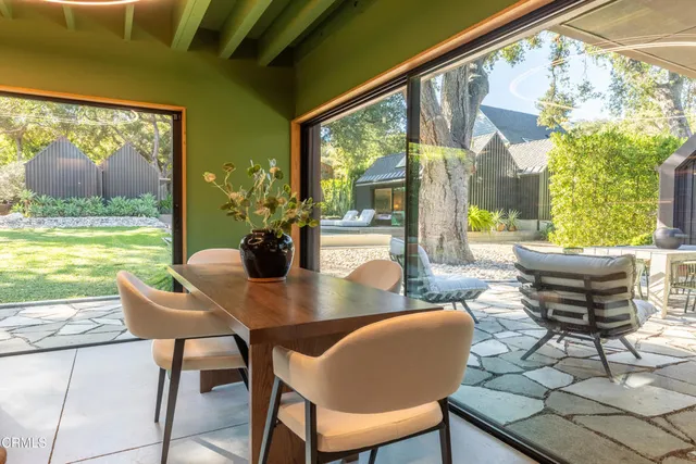 a bedroom with a bed and painting on the wall