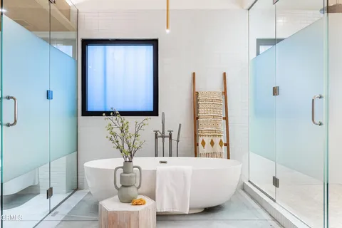 a view of a hallway with wooden floors and furniture