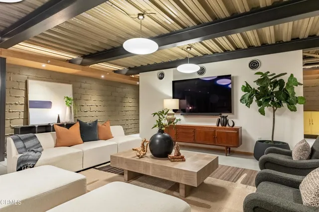 a building outdoor space with patio furniture and potted plants