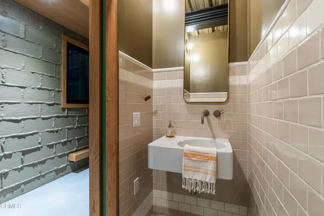 a view of a backyard with swimming pool and trees