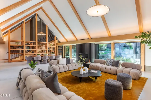 a living room with furniture and a floor to ceiling window