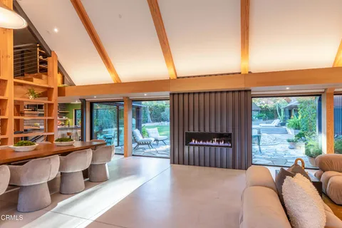 a living room with furniture potted plant and a large window