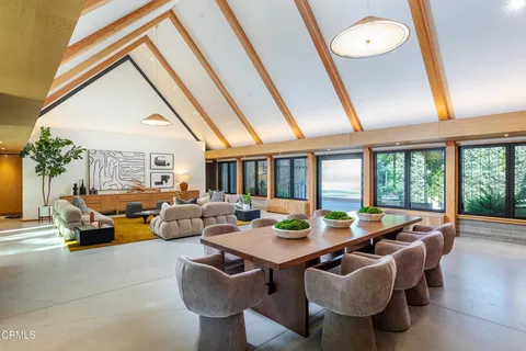 a very nice looking room with a large window and a chandelier