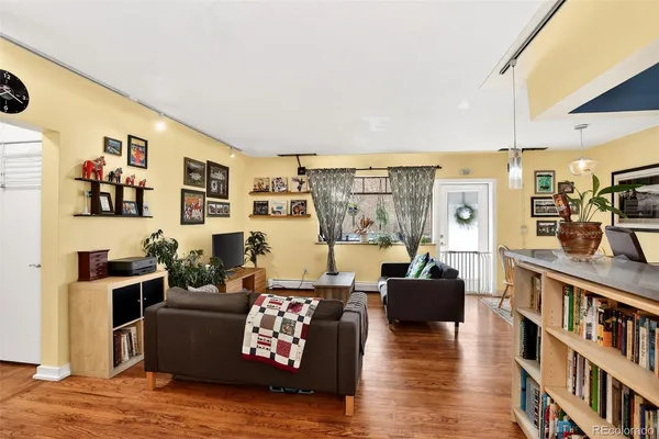 a living room with furniture and a book shelf