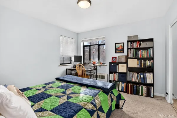 a bed room with a bed and a book shelf