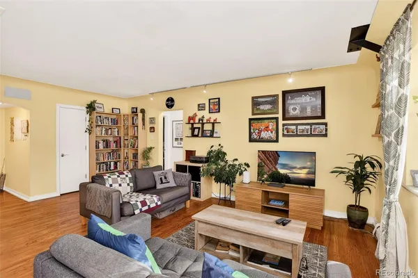 a living room with furniture a rug and a flat screen tv