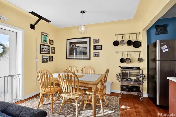 a view of a dining room with furniture and wooden floor