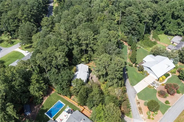 an aerial view of a house with a yard and lake view