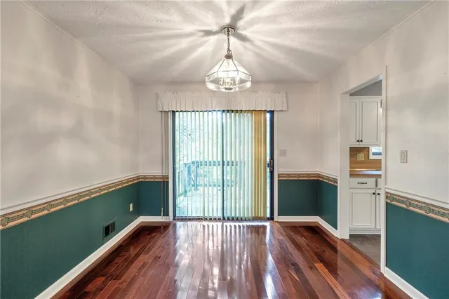 a view of wooden floor and windows in a room