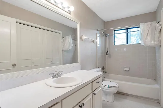 a bathroom with a sink toilet vanity and shower