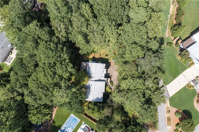 an aerial view of a house with a yard and fountain
