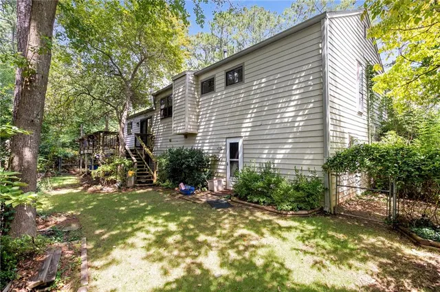 a view of a house with a yard and sitting area