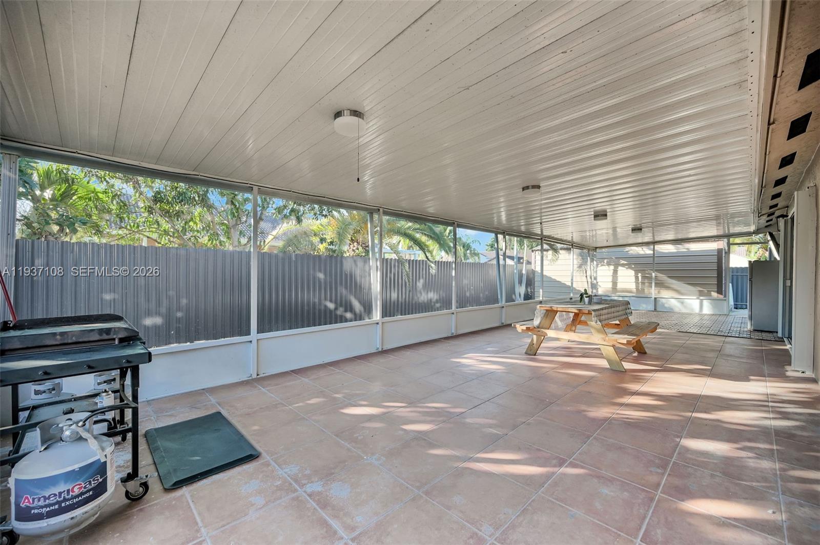 17020 Southwest 149th Avenue Miami, FL 33187 - Photo 15 of 68 a backyard of a house with a garden and outdoor seating