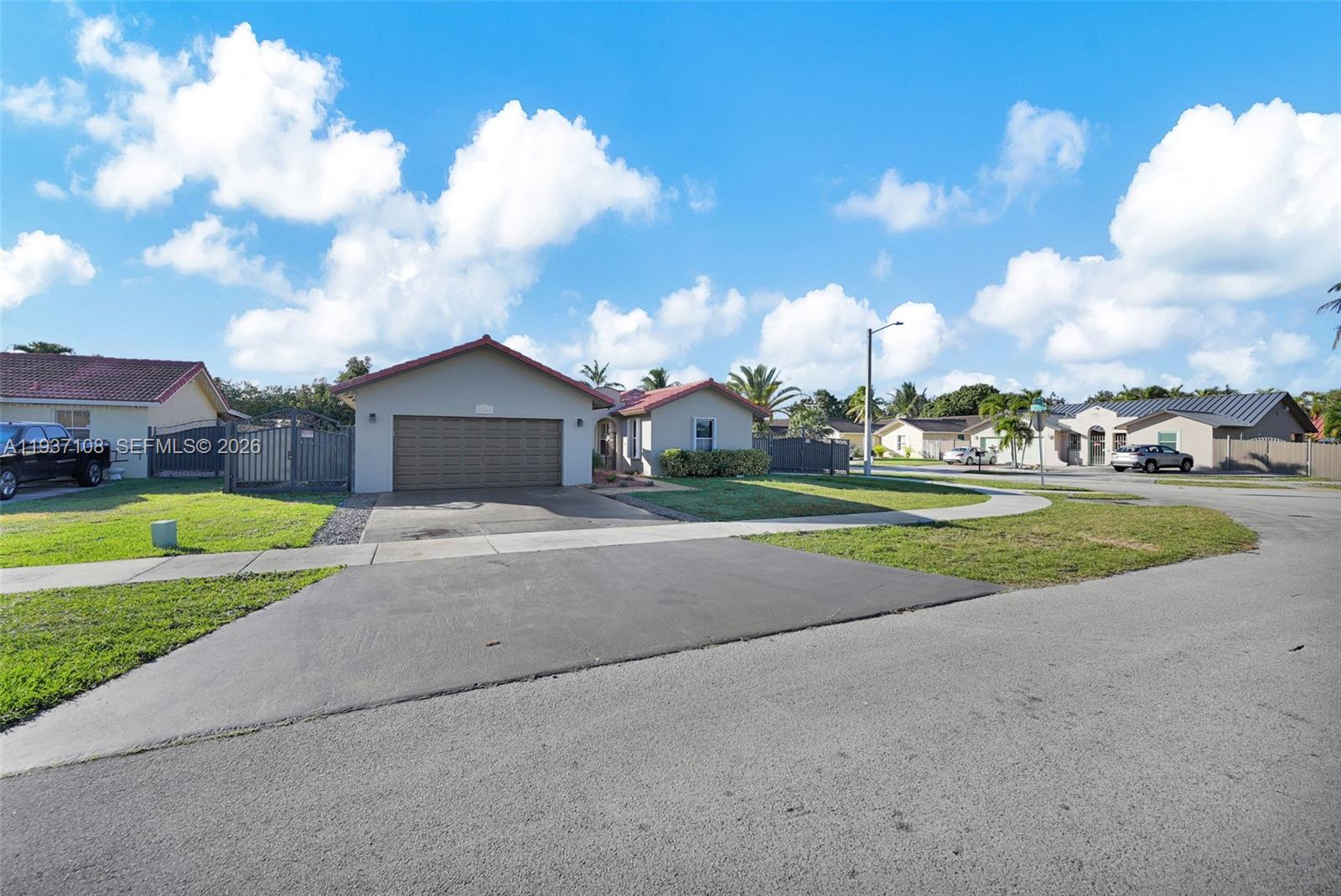 17020 Southwest 149th Avenue Miami, FL 33187 - Photo 2 of 68 a view of a house with a big yard and large trees