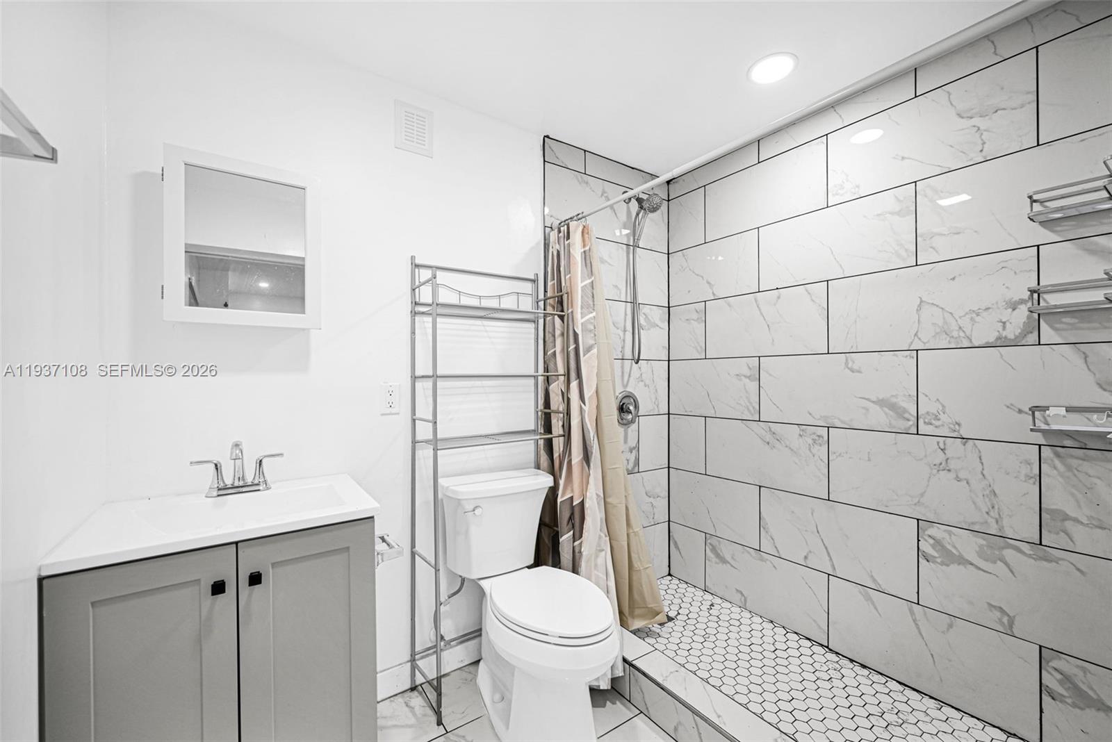 17020 Southwest 149th Avenue Miami, FL 33187 - Photo 30 of 68 a bathroom with a sink toilet and shower