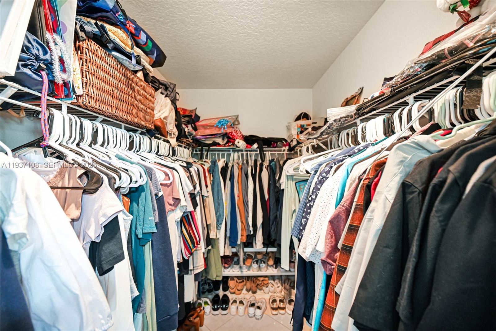 17020 Southwest 149th Avenue Miami, FL 33187 - Photo 32 of 68 a view of walk in closet with clothes and shoes