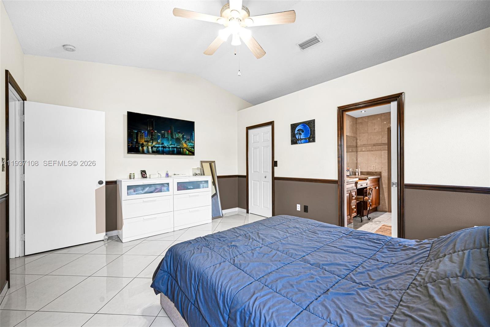 17020 Southwest 149th Avenue Miami, FL 33187 - Photo 34 of 68 a bedroom with a bed and a flat screen tv