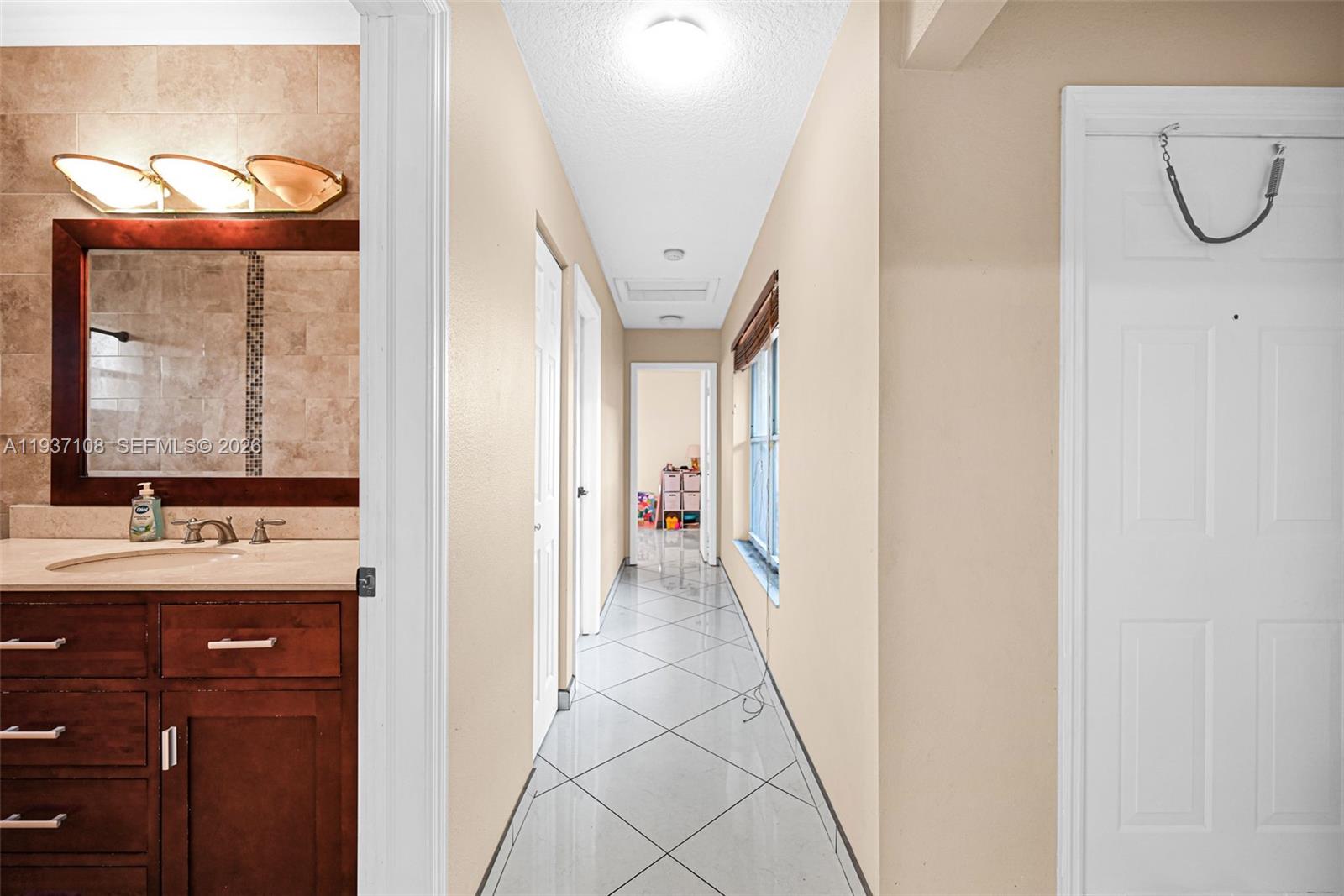 17020 Southwest 149th Avenue Miami, FL 33187 - Photo 40 of 68 a bathroom with a granite countertop sink a mirror and a shower
