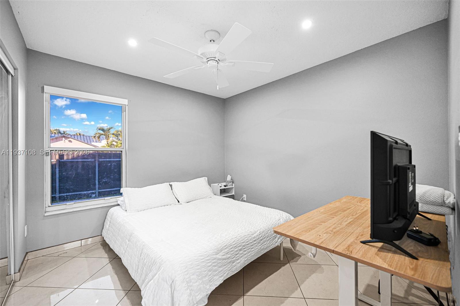 17020 Southwest 149th Avenue Miami, FL 33187 - Photo 41 of 68 a bedroom with a bed and a flat screen tv