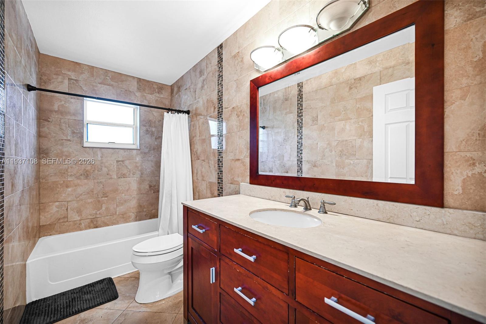17020 Southwest 149th Avenue Miami, FL 33187 - Photo 43 of 68 a bathroom with a sink a toilet and shower