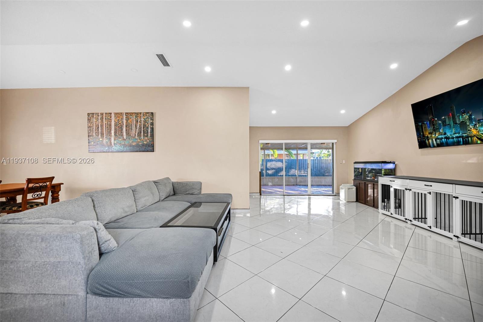 17020 Southwest 149th Avenue Miami, FL 33187 - Photo 45 of 68 a living room with furniture and a flat screen tv