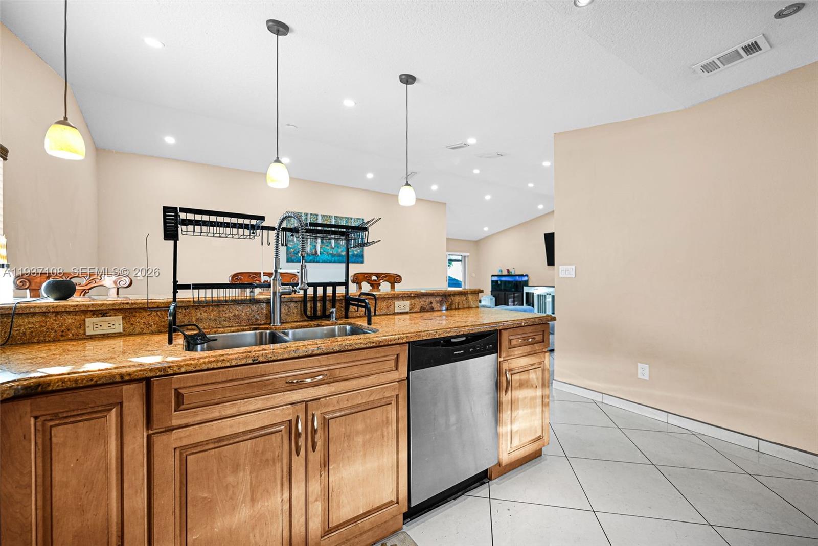 17020 Southwest 149th Avenue Miami, FL 33187 - Photo 56 of 68 a kitchen with stainless steel appliances granite countertop a sink a stove and a wooden cabinets