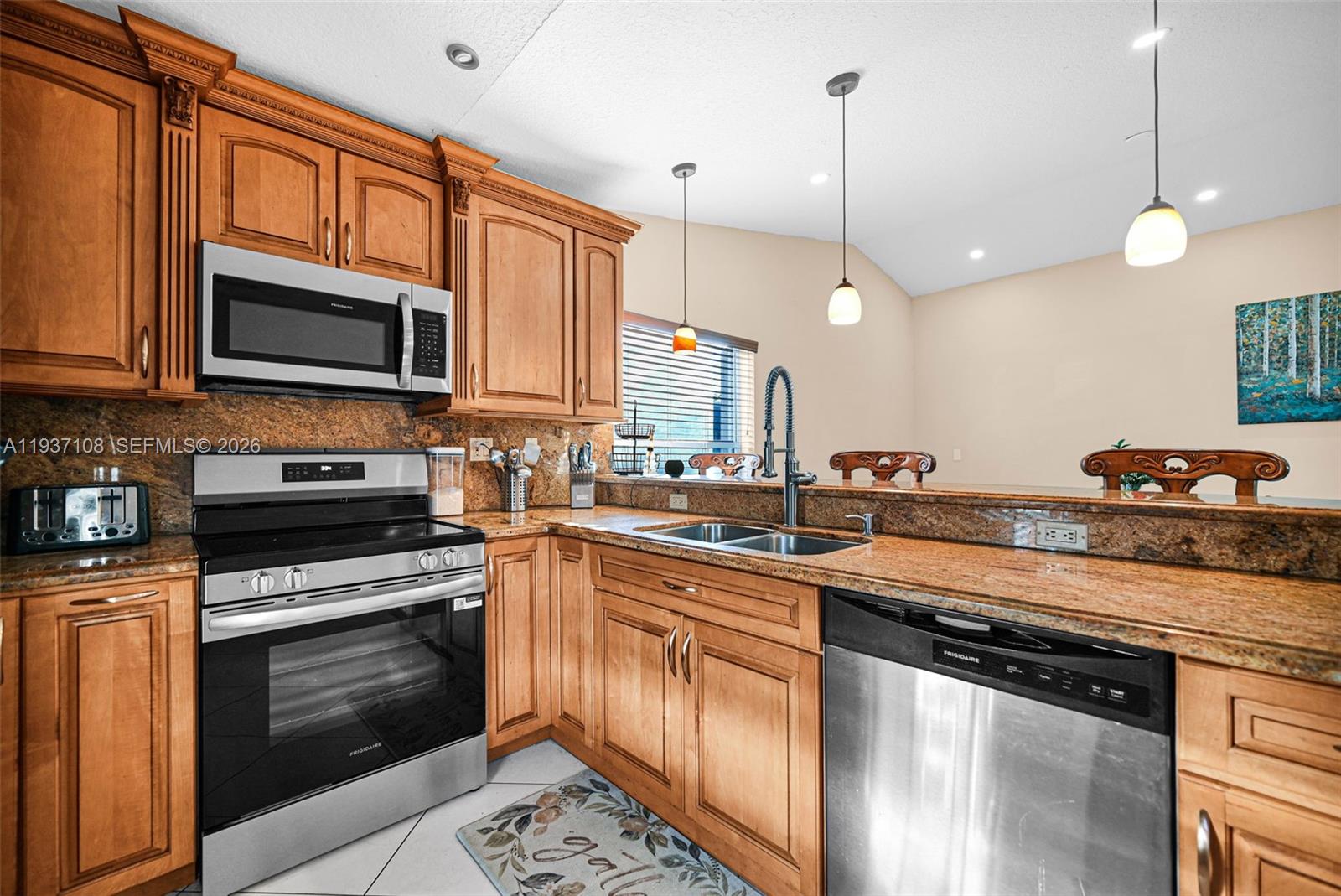 17020 Southwest 149th Avenue Miami, FL 33187 - Photo 58 of 68 a kitchen with stainless steel appliances granite countertop a stove a sink and a microwave