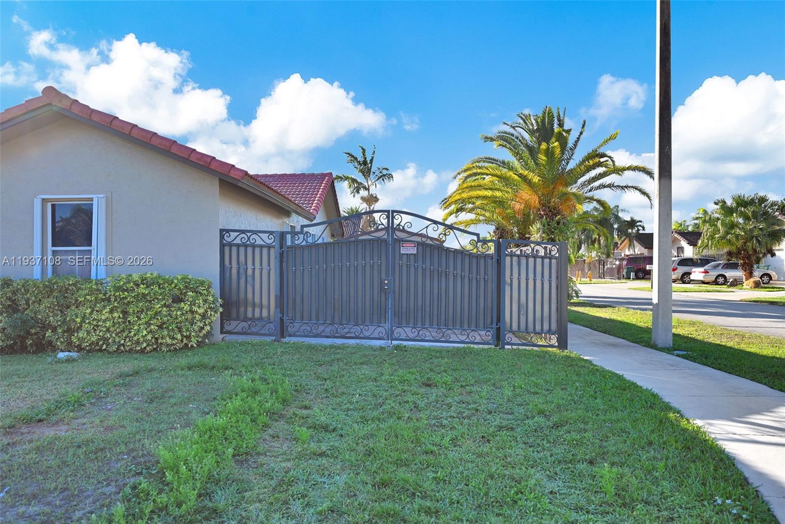 17020 Southwest 149th Avenue Miami, FL 33187 - Photo 7 of 68 a view of a backyard with potted plants and wooden fence